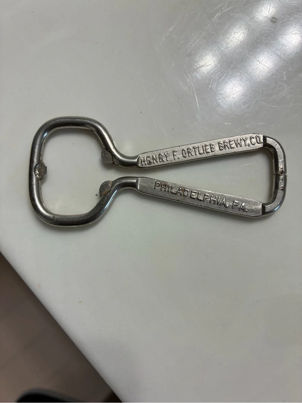 Vintage wire-loop advertising bottle opener from the Henry F. Ortlieb Brewing Co